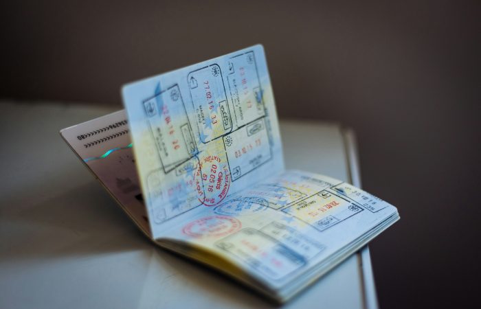 Passport with multiple visas and immigration stamps representing extraordinary ability visa options