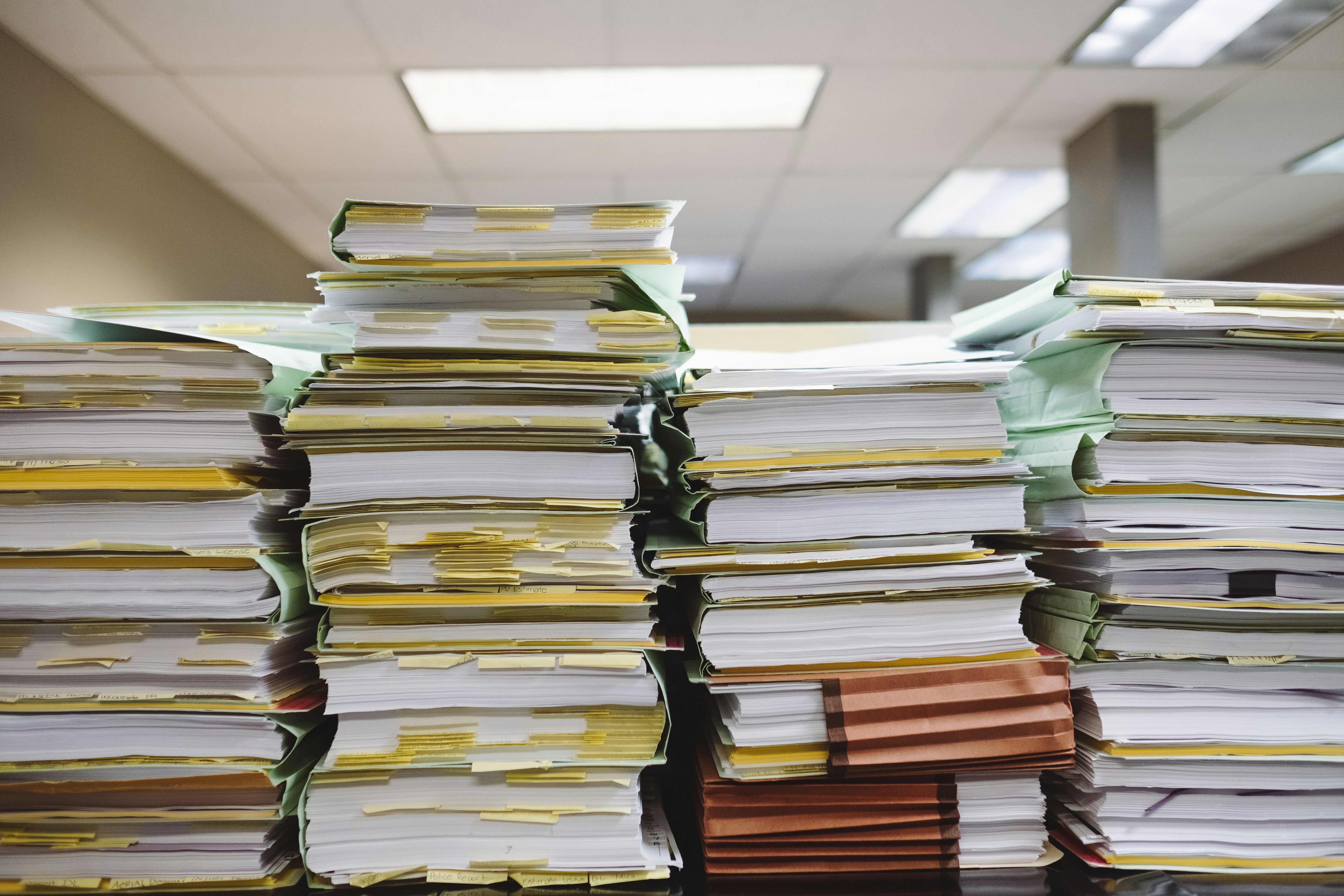 Stacks of immigration documents representing the complexity of U.S. immigration processes