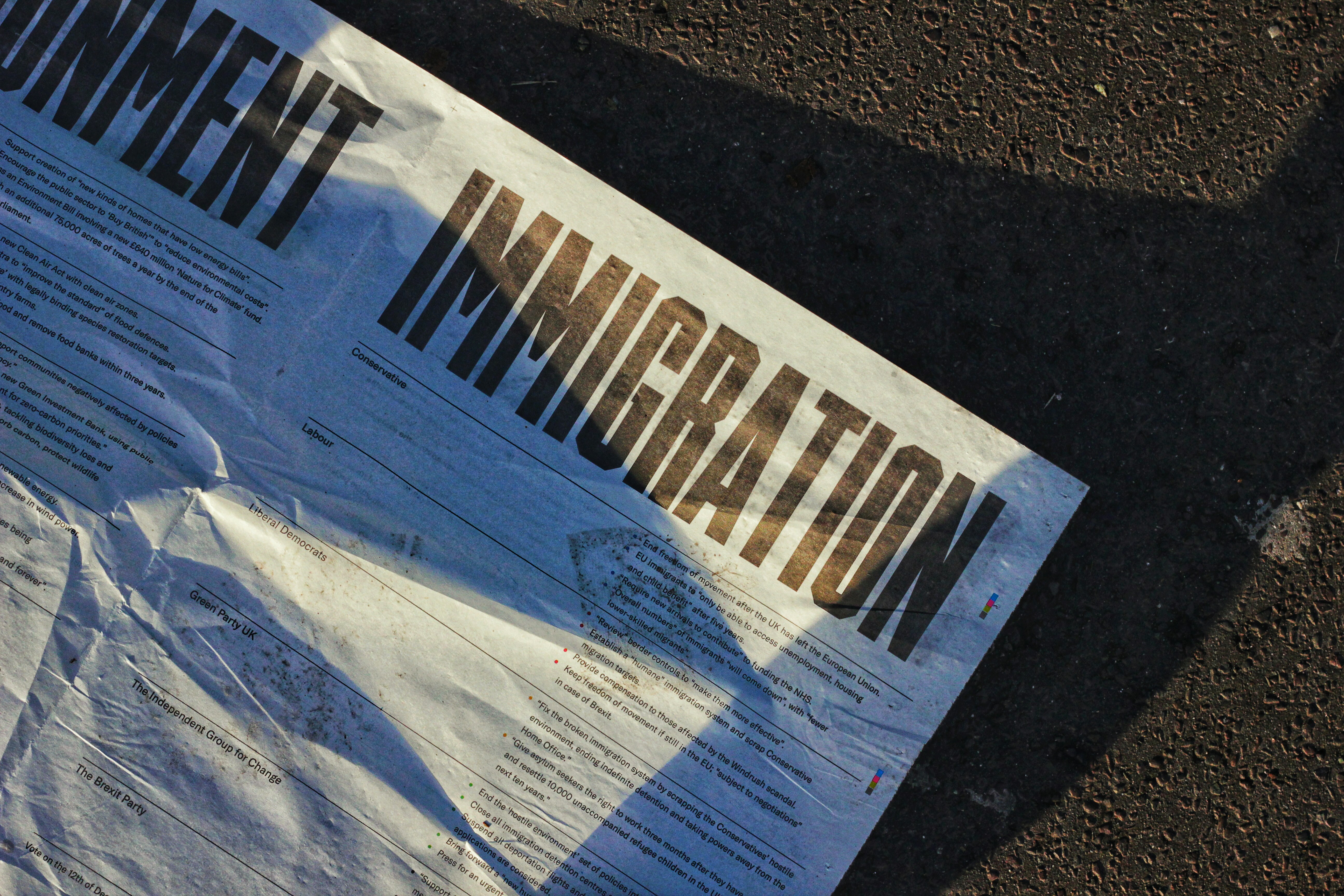Newspaper featuring immigration headlines representing O-1B visas and EB-1 green card options for artists and creative professionals.