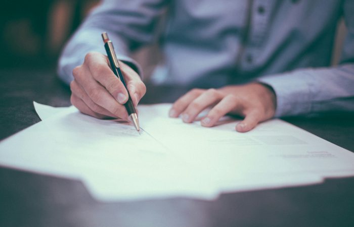 Professional reviewing documents for EB-2 NIW and O-1A immigration options