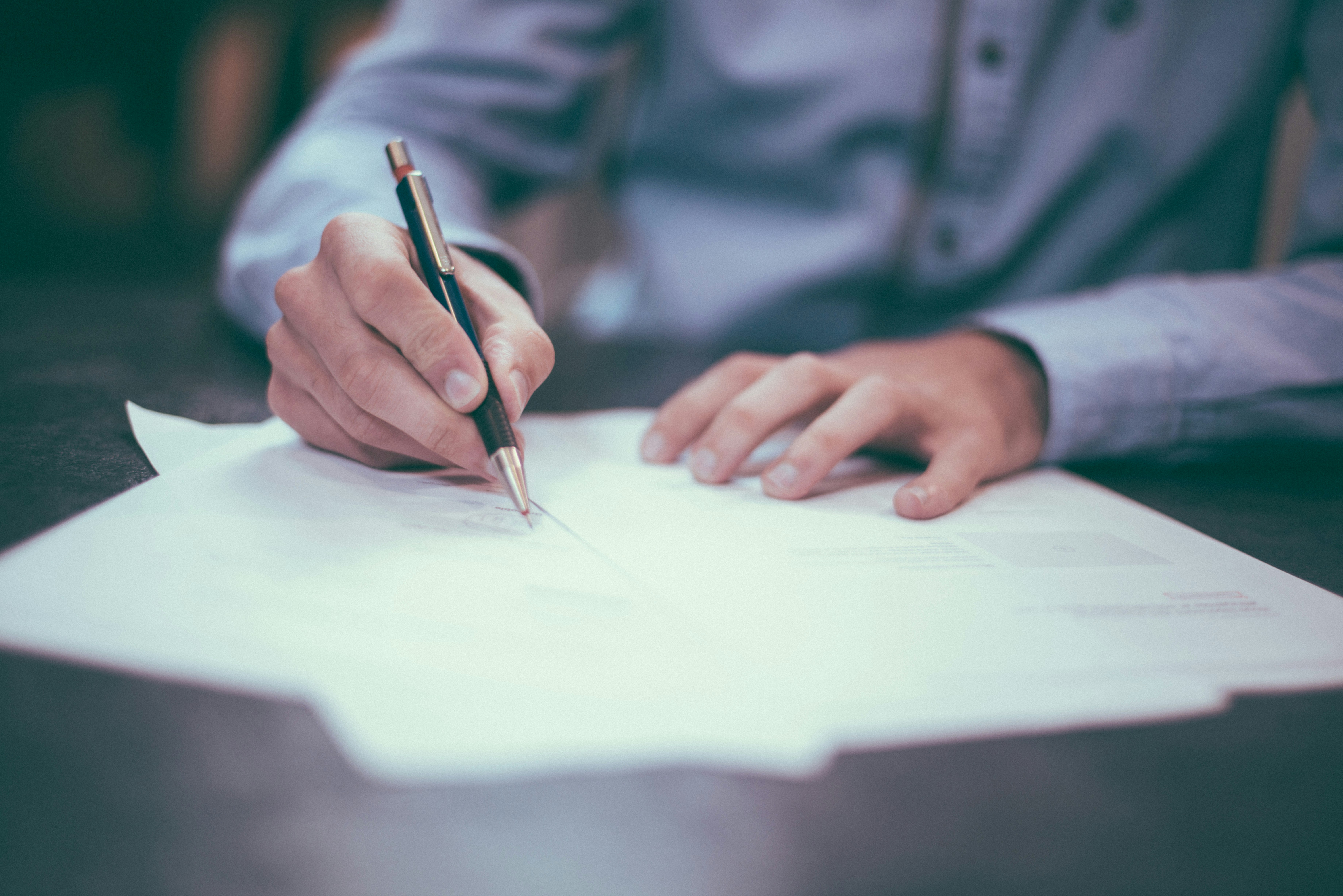 Professional reviewing documents for EB-2 NIW and O-1A immigration options
