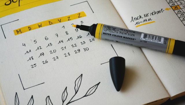 Calendar page for September with a yellow highlighter marker indicating important dates for visa processing.