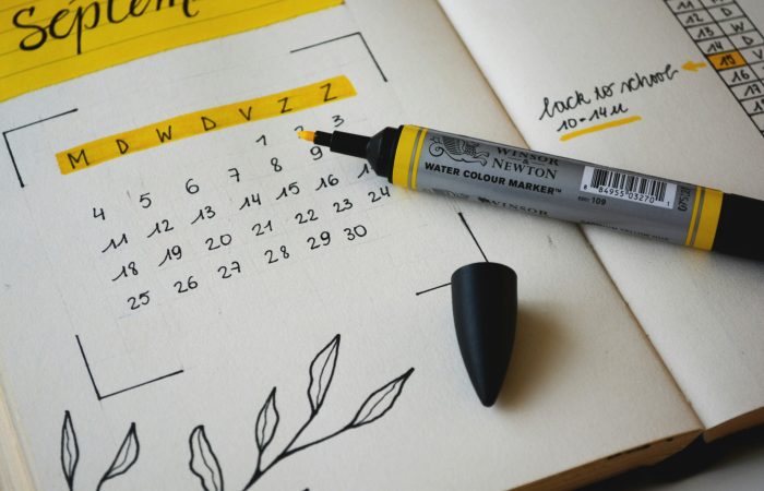 Calendar page for September with a yellow highlighter marker indicating important dates for visa processing.