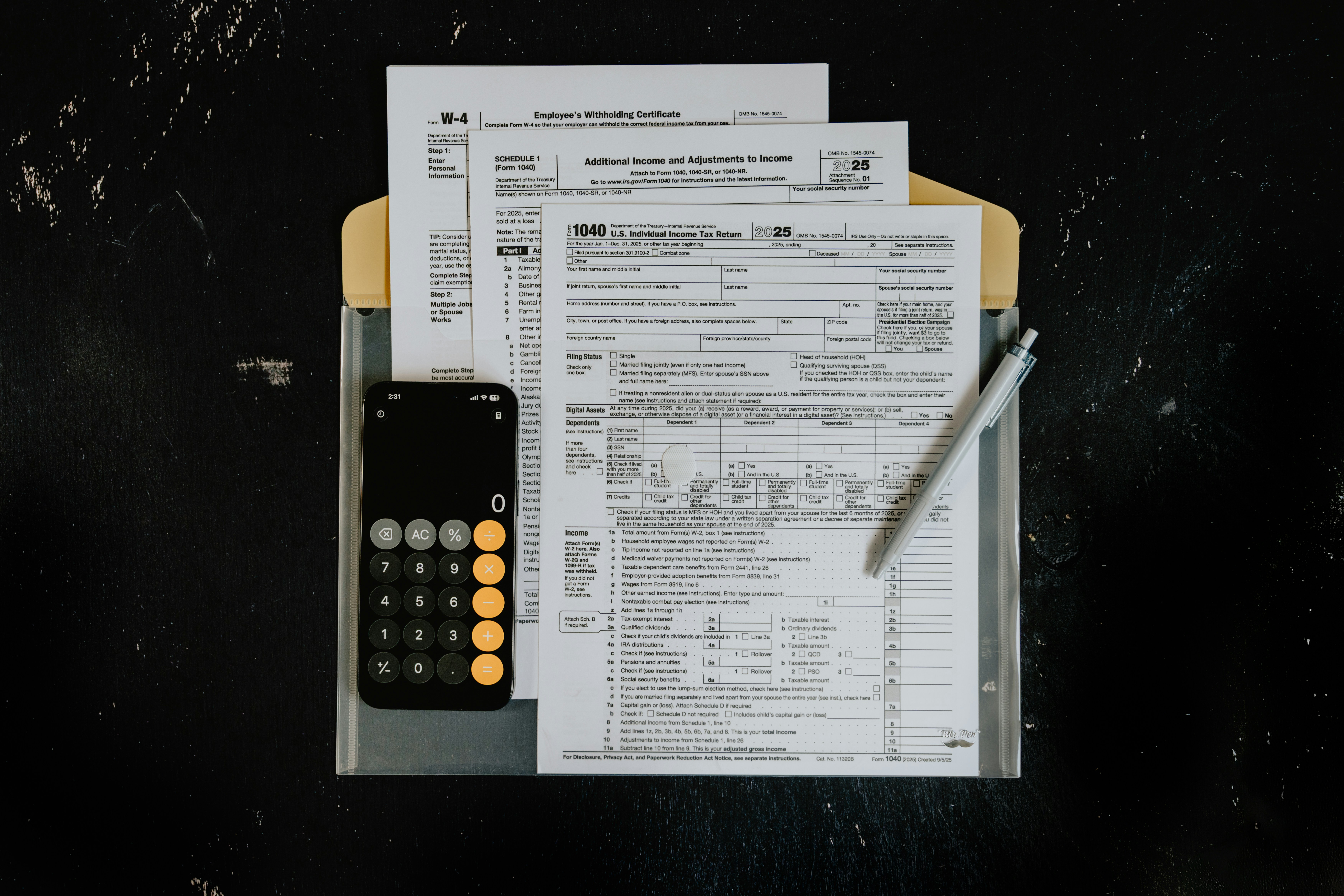 Tax forms, calculator, and a pen on a desk representing cross-border financial services and financial planning.