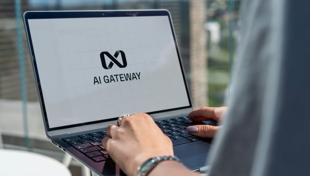 Person working on a laptop displaying an AI gateway interface, representing artificial intelligence research and technology development.