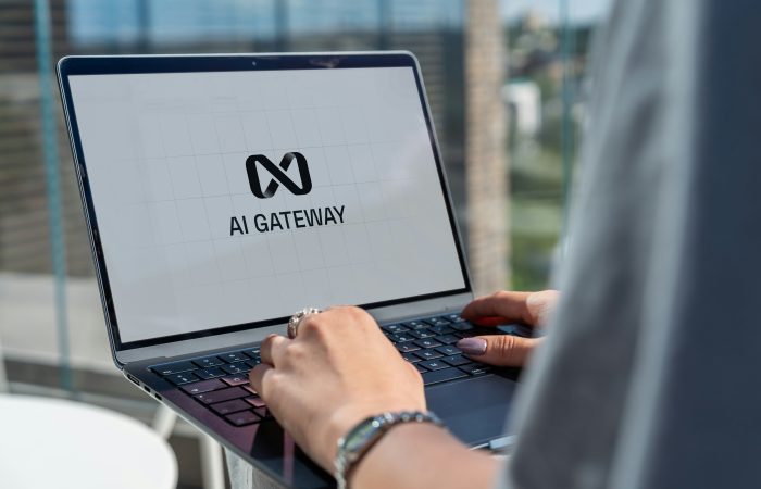 Person working on a laptop displaying an AI gateway interface, representing artificial intelligence research and technology development.
