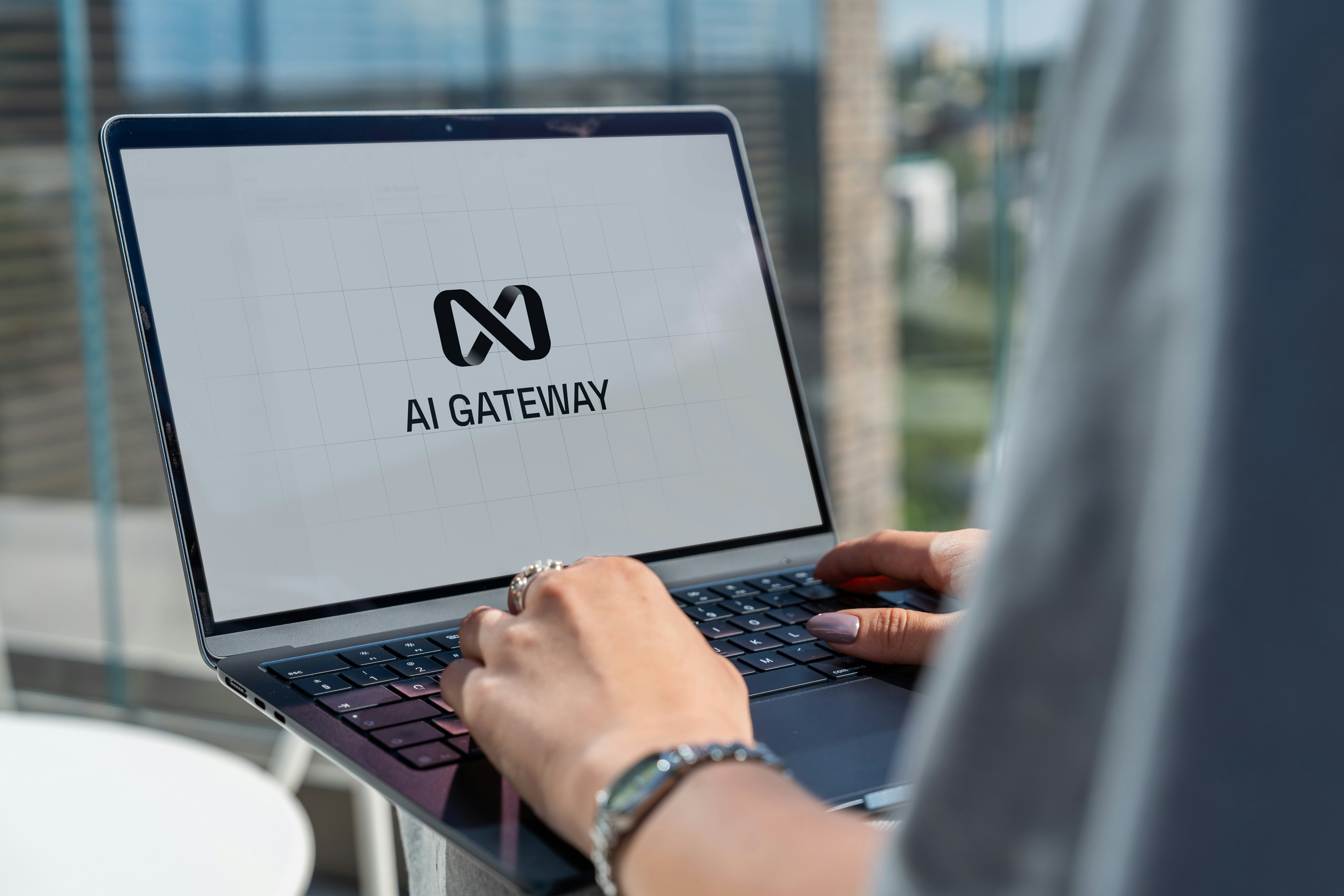 Person working on a laptop displaying an AI gateway interface, representing artificial intelligence research and technology development.