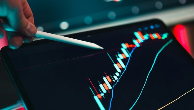 Financial charts and market analysis displayed on a tablet for EB-5 immigrant investors