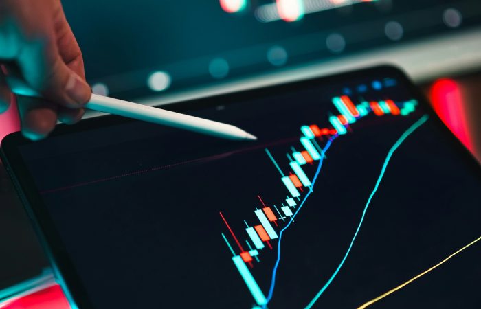 Financial charts and market analysis displayed on a tablet for EB-5 immigrant investors
