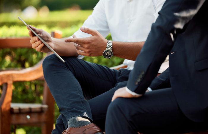 Business professionals reviewing corporate strategy on a tablet for an EB-2 NIW petition