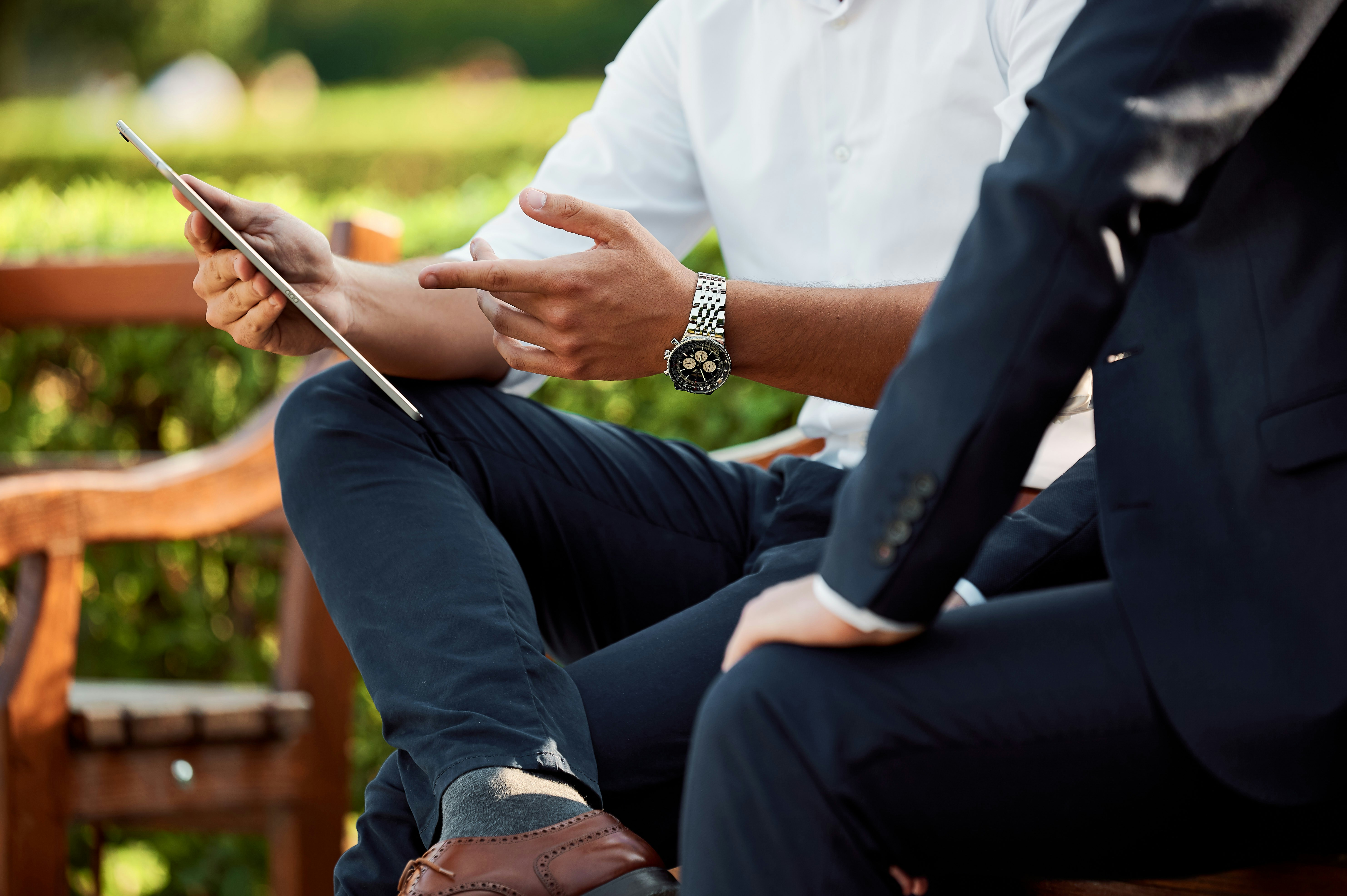 Business professionals reviewing corporate strategy on a tablet for an EB-2 NIW petition
